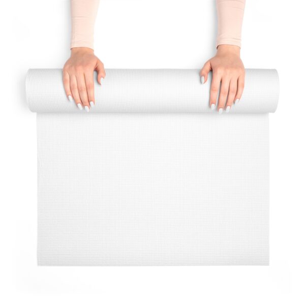 Plain foam yoga mat unrolled on the floor with the words “Your Design Here” printed across the top surface to show the customizable area.